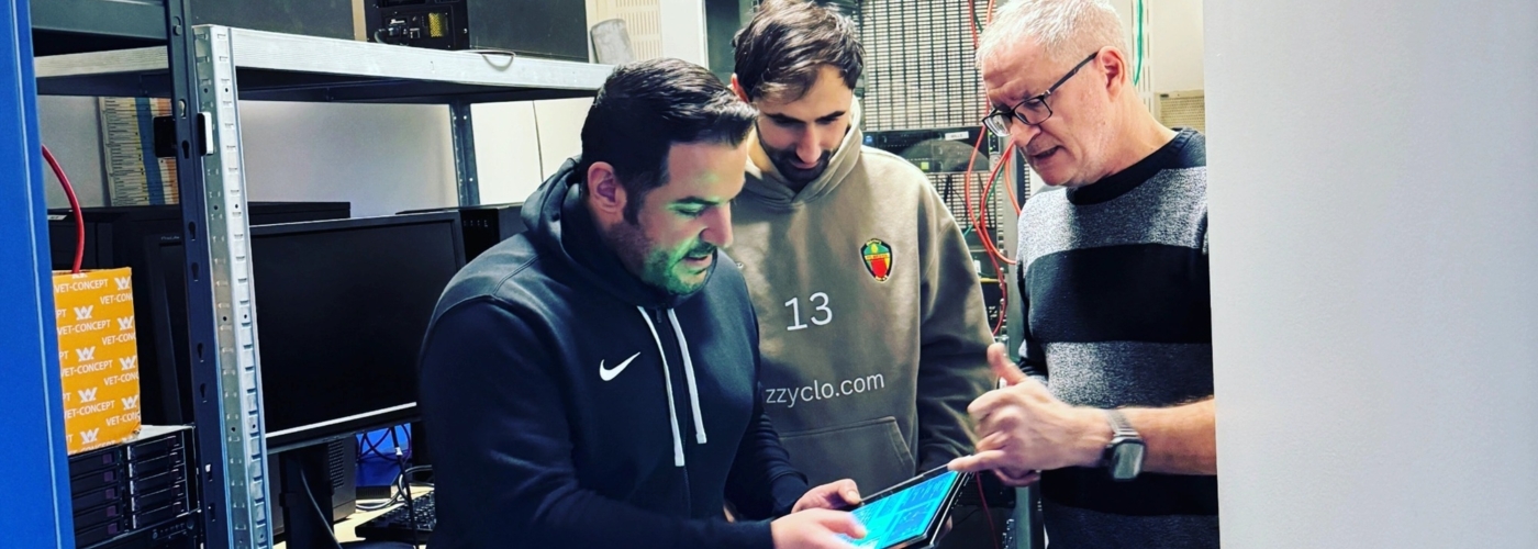 Drei Männer schauen auf ein Tablet