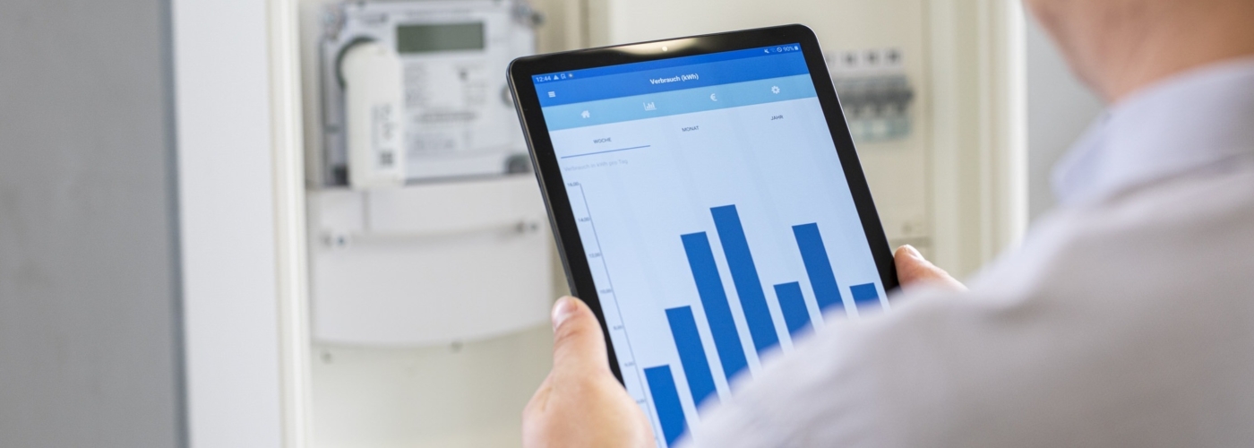 Person hält einTablet, das ein Balkendiagramm zeigt.